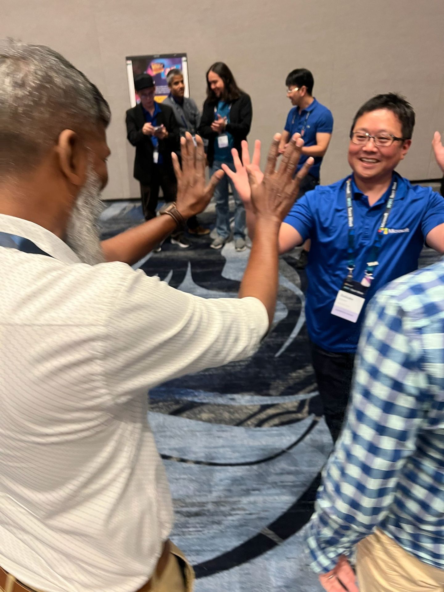 Players from Microsoft celebrating with a high-five during a Great Scott! event.