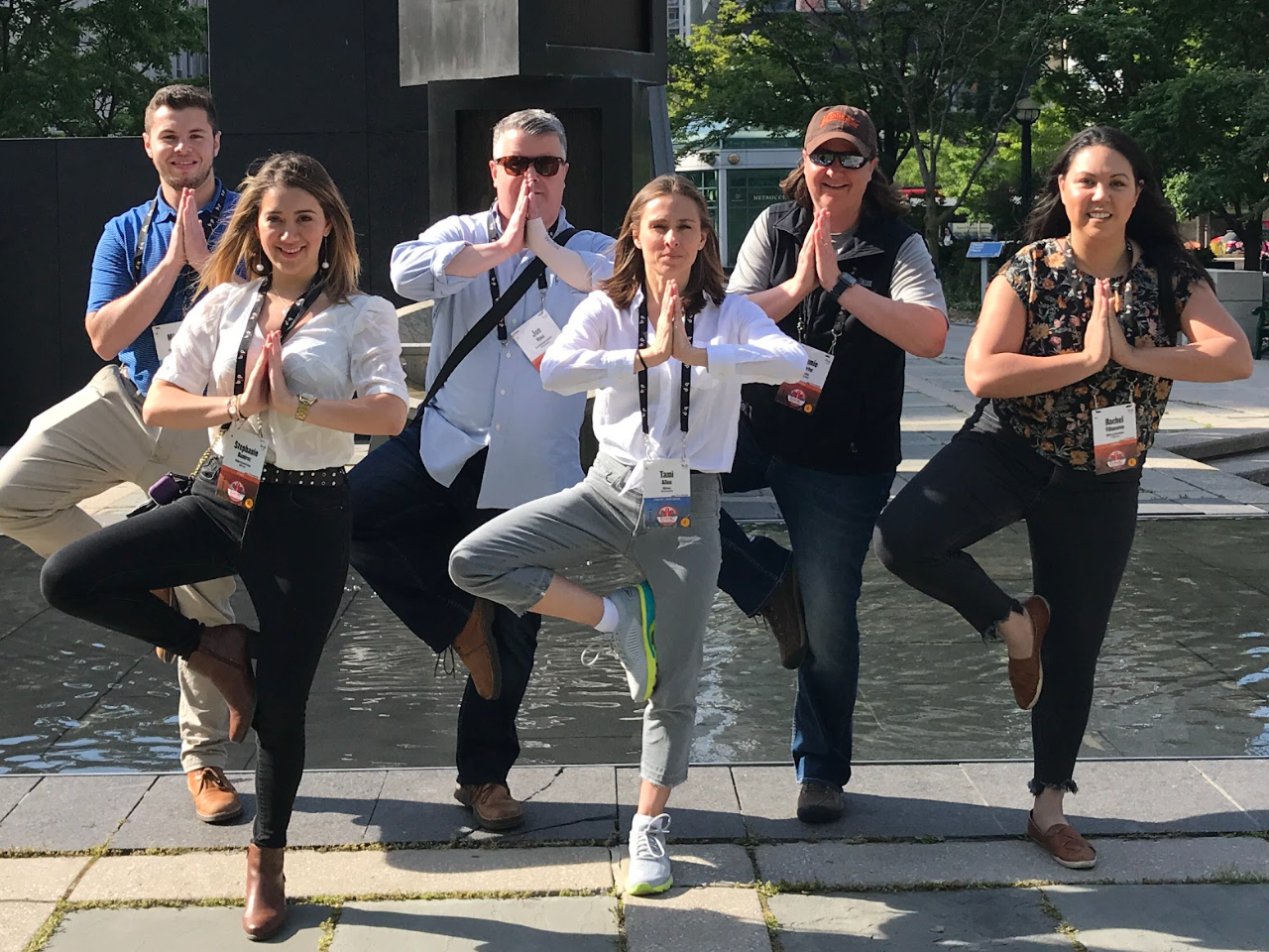 Corporate team taking a group selfie during a downtown city scavenger hunt.