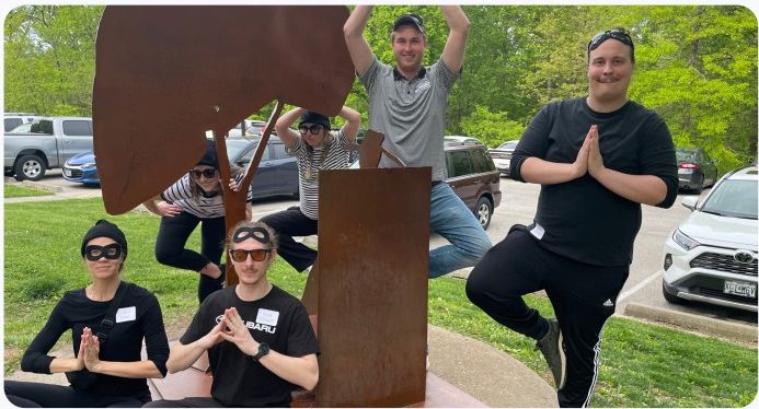 A team posing together during a Who Kidnapped Your Boss challenge.